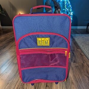 Vintage Lil Bum rolling suitcase in purple and pink with yellow logo.